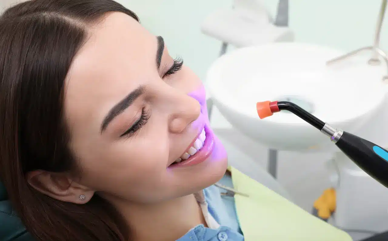 Woman Undergoing Tooth Whitening Procedure 